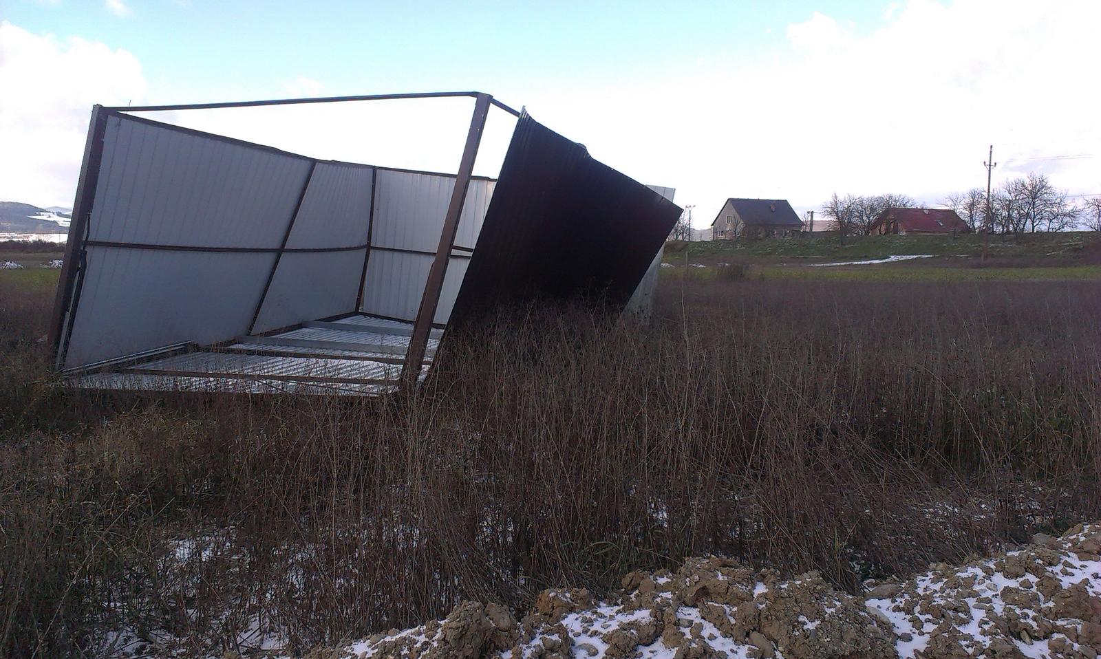 Odfúknutá plechová garáž pre jedno auto v poli
