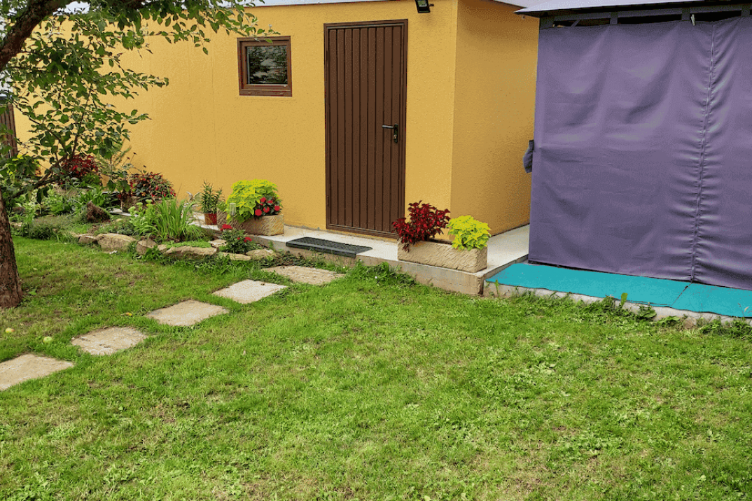 Žltá garáž pre jedno auto na záhrade