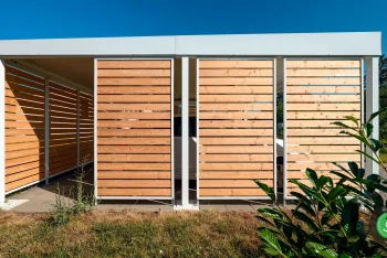 Bočná strana prístrešku pre dve autá s hnedými elementami