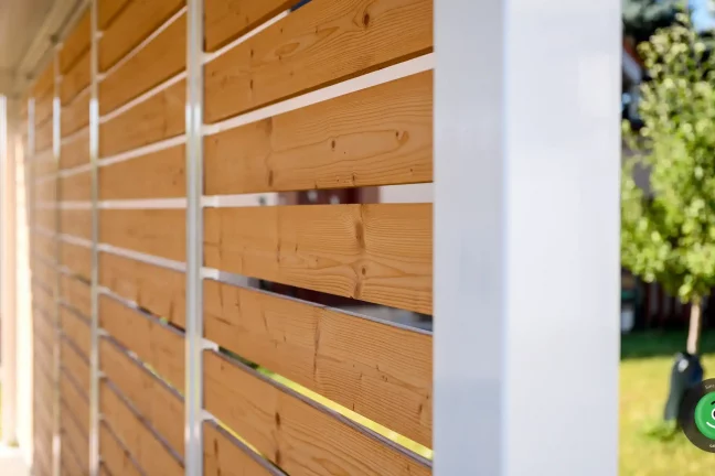 Detail hnedej drevenej výplne na prístrešku pre dve autá.