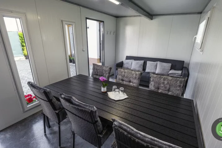 Detail na interiér záhradného domčeka s bielymi stenami.