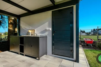 Detail na dvere od záhradného domčeka a letnú kuchynku pod prístreškom